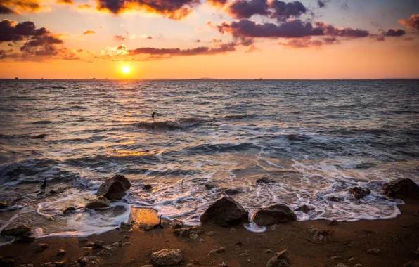 Picture sea, the sun, stones, dawn