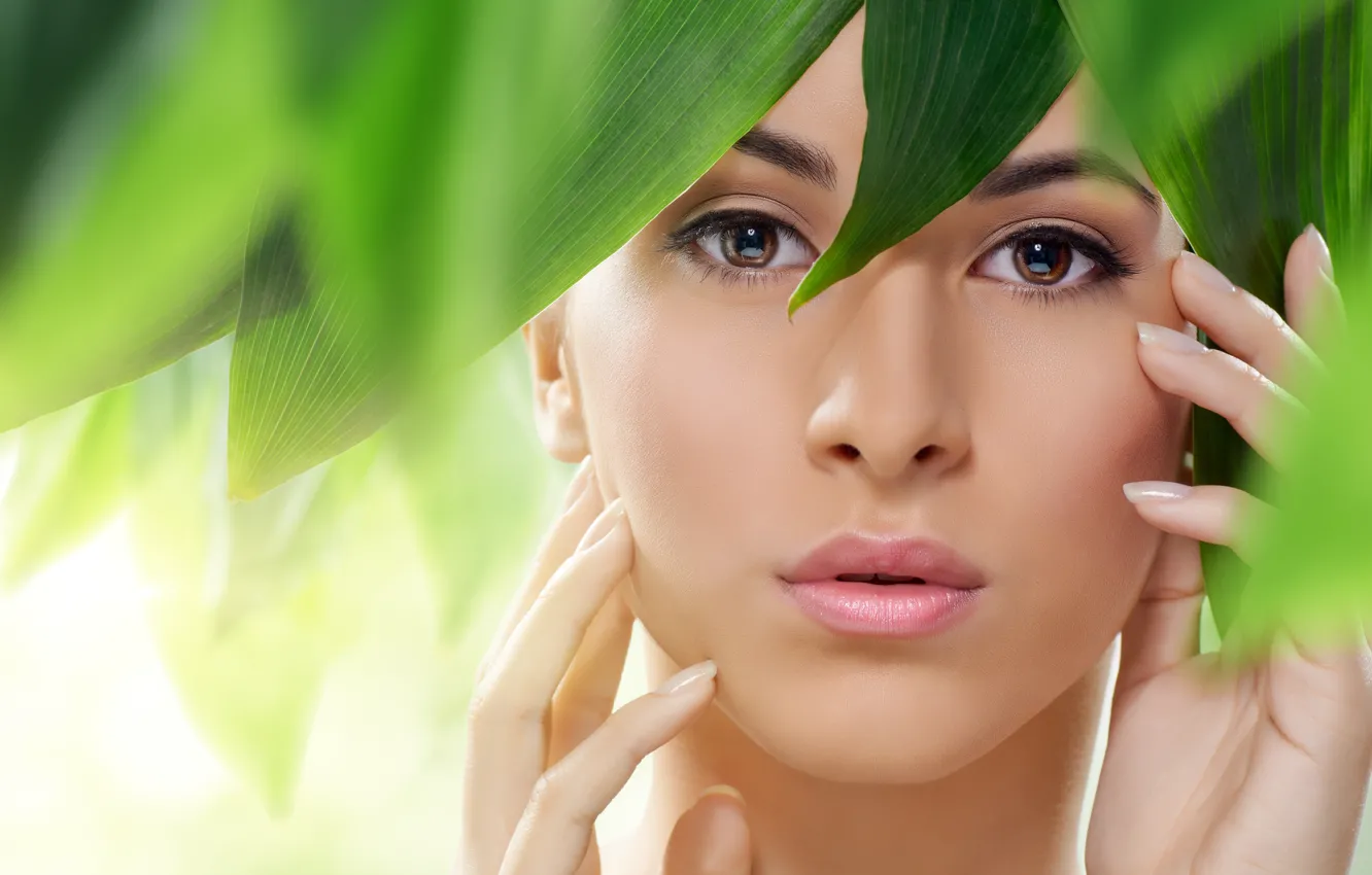 Photo wallpaper look, girl, face, green leaves, hands, lips, brown eyes